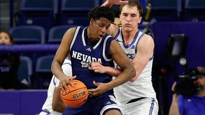 Feb 4, 2025; Colorado Springs, Colorado, USA; Nevada Wolf Pack forward Justin McBride (21) and Air Force Falcons center Wesley Celichowski (51) battle for the ball in the first half at Clune Arena. Mandatory Credit: Isaiah J. Downing-Imagn Images