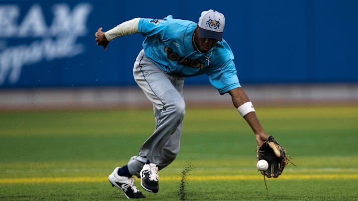 Fond du Lac Dock Spiders outfielder Chandler Simpson (14) scoops up the ball in the fourth inning Booyah at Capital Credit Union Park in Green Bay, Wisconsin.