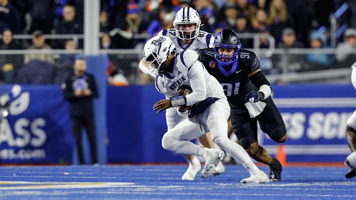 Boise State Broncos defensive end Ahmed Hassanein tackles Nevada Wolf Pack quarterback Brendon Lewis.