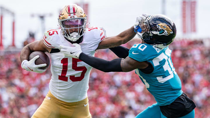 September 28, 2025; Santa Clara, California, USA; San Francisco 49ers wide receiver Jauan Jennings (15) is tackled by Jacksonville Jaguars cornerback Montaric Brown (30) during the second quarter at Levi's Stadium. Mandatory Credit: Kyle Terada-Imagn Images