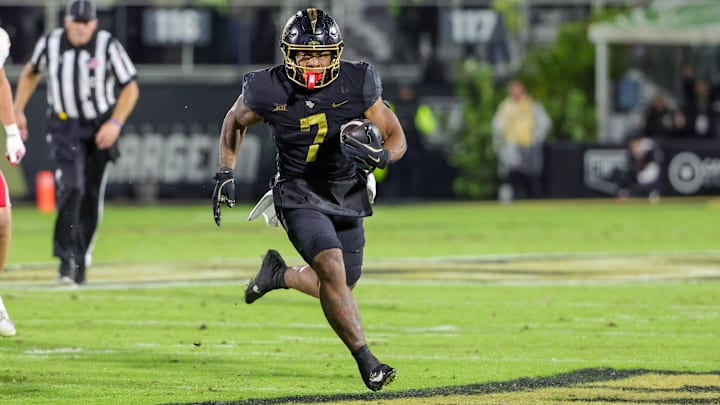 Nov 29, 2024; Orlando, Florida, USA; UCF Knights running back RJ Harvey (7) runs the ball during the second quarter against the Utah Utes at FBC Mortgage Stadium. Mandatory Credit: Mike Watters-Imagn Images