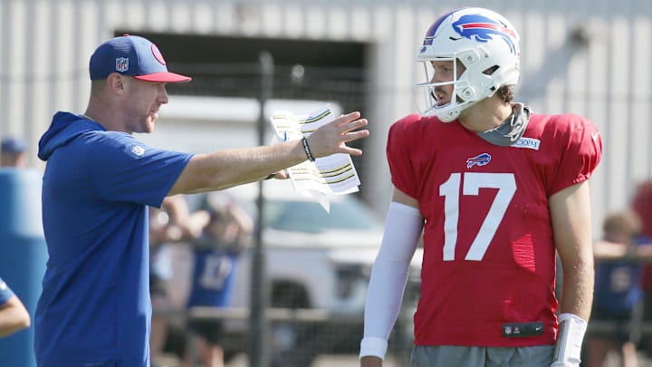 Bills quarterback Josh Allen talks with offensive coordinator Joe Brady between drills. Bills quarterback Josh Allen talks with offensive coordinator Joe Brady between drills.