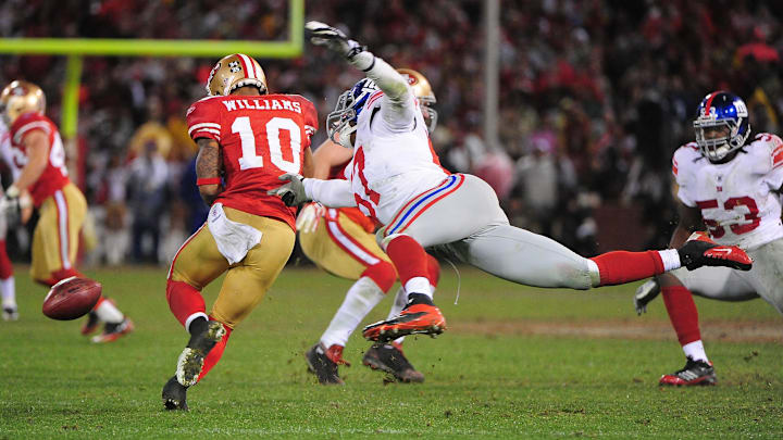 New York Giants middle linebacker Jacquian Williams (57) knocks the ball out of San Francisco 49ers wide receiver Kyle Williams (10)