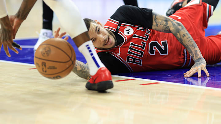 Feb 24, 2025; Philadelphia, Pennsylvania, USA; Chicago Bulls guard Lonzo Ball (2) reaches for a loose ball against the Philadelphia 76ers during the first quarter at Wells Fargo Center. Mandatory Credit: Bill Streicher-Imagn Images
