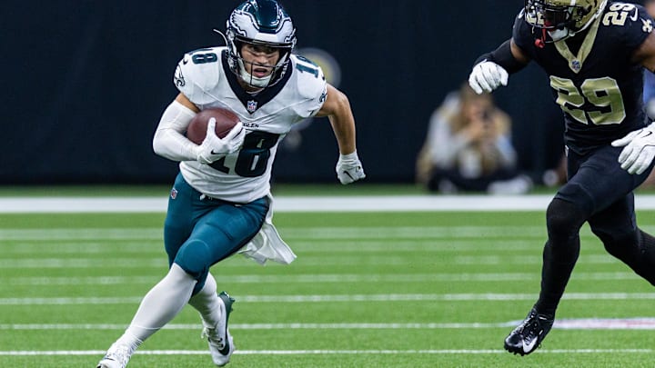 Sep 22, 2024; New Orleans, Louisiana, USA; Philadelphia Eagles wide receiver Britain Covey (18) runs a pass back against New Orleans Saints cornerback Paulson Adebo (29) during the first half at Caesars Superdome. Mandatory Credit: Stephen Lew-Imagn Images