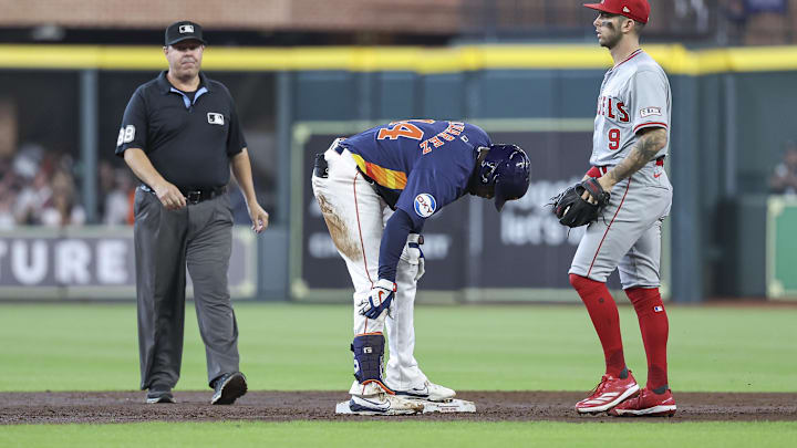 Houston Astros left fielder Yordan Alvarez (left) holds his leg after sliding into second during a game against the Los Angeles Angels on Sunday at Minute Maid Park. Houston Astros left fielder Yordan Alvarez (left) holds his leg after sliding into second during a game against the Los Angeles Angels on Sunday at Minute Maid Park.