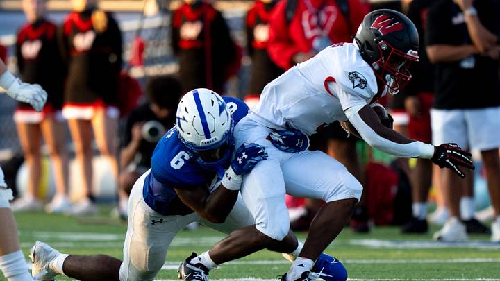 St. Xavier linebacker Aden Reeder (6) tackles Lakota West running back Kenyon Norman (3) in the second quarter between Lakota West and St. Xavier at St. Xavier High School in Cincinnati on Aug. 22, 2025.