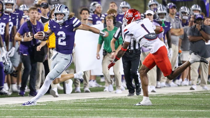 Sep 13, 2024; Manhattan, Kansas, USA; Kansas State Wildcats quarterback Avery Johnson (2) is forced out of bounds by Arizona Wildcats defensive back Tacario Davis (1) during the third quarter at Bill Snyder Family Football Stadium. Mandatory Credit: Scott Sewell-Imagn Images