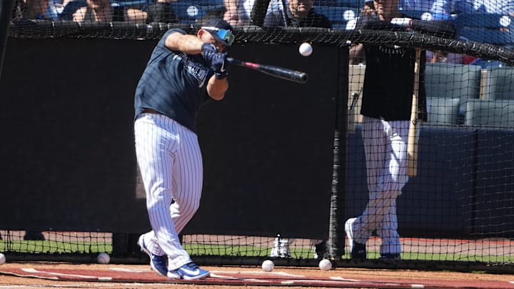 Feb 17, 2025; Tampa, FL, USA; New York Yankees outfielder Jasson Dominguez (24) hits a ball as manager Aaron Boone (17) and outfielder Cody Bellinger (35) look on during spring training batting practice at George M. Steinbrenner Field.