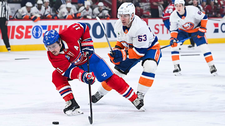 Mar 21, 2026; Montreal, Quebec, CAN; Montreal Canadiens right wing Brendan Gallagher (11) plays the puck against New York Islanders center Casey Cizikas (53) during the first period at Bell Centre. Mandatory Credit: David Kirouac-Imagn Images