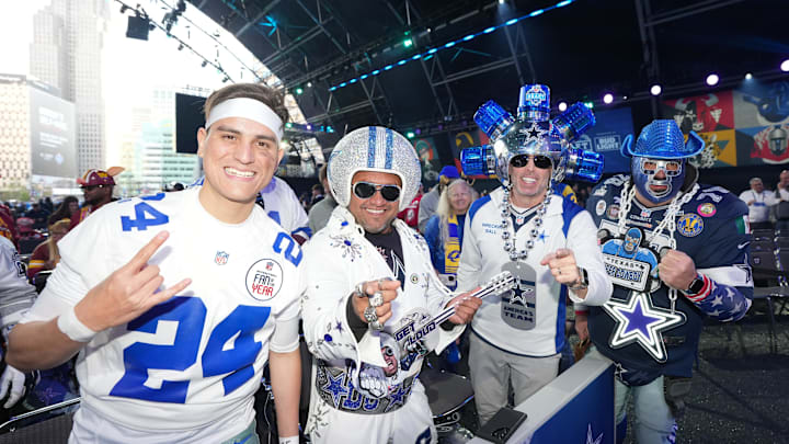 Dallas Cowboys fans pose for a photograph during the 2024 NFL Draft at Campus Martius Park and Hart Plaza. 