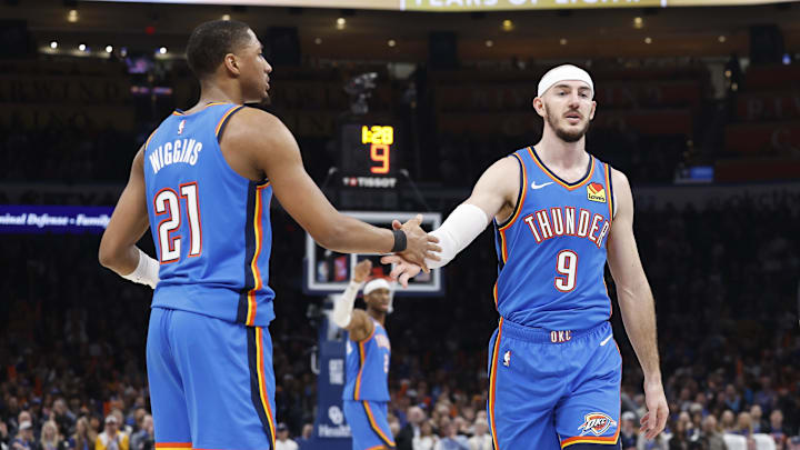Feb 7, 2025; Oklahoma City, Oklahoma, USA; Oklahoma City Thunder guard Aaron Wiggins (21) high-fives guard Alex Caruso (9) after a play against the Toronto Raptors during the second quarter at Paycom Center. Mandatory Credit: Alonzo Adams-Imagn Images