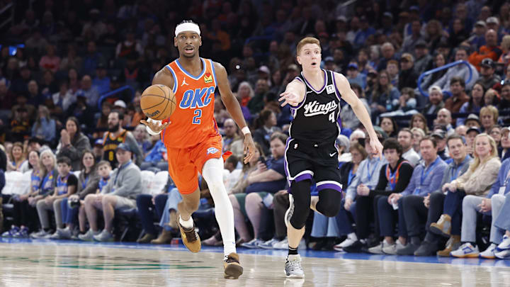Feb 1, 2025; Oklahoma City, Oklahoma, USA; Oklahoma City Thunder guard Shai Gilgeous-Alexander (2) dribbles the ball down the court ahead of Sacramento Kings guard Kevin Huerter (9) during the second half at Paycom Center. Mandatory Credit: Alonzo Adams-Imagn Images Feb 1, 2025; Oklahoma City, Oklahoma, USA; Oklahoma City Thunder guard Shai Gilgeous-Alexander (2) dribbles the ball down the court ahead of Sacramento Kings guard Kevin Huerter (9) during the second half at Paycom Center. Mandatory Credit: Alonzo Adams-Imagn Images