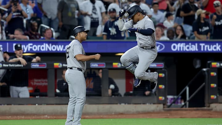 Jun 25, 2024; New York City, New York, USA; New York Yankees right fielder Juan Soto (22) celebrates with third base coach Luis Rojas (67) as he rounds the bases after hitting a solo home run against the New York Mets during the fifth inning at Citi Field. Mandatory Credit: Brad Penner-Imagn Images