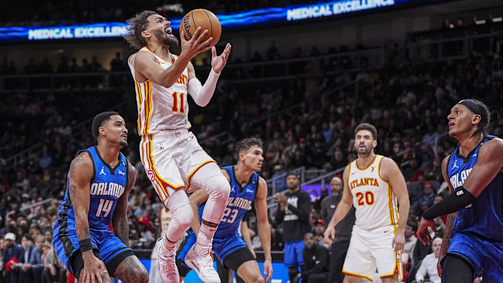 Atlanta Hawks guard Trae Young (11) goes to wards the basket behind Orlando Magic guard Gary Harris (14) during the second half at State Farm Arena. Atlanta Hawks guard Trae Young (11) goes to wards the basket behind Orlando Magic guard Gary Harris (14) during the second half at State Farm Arena.