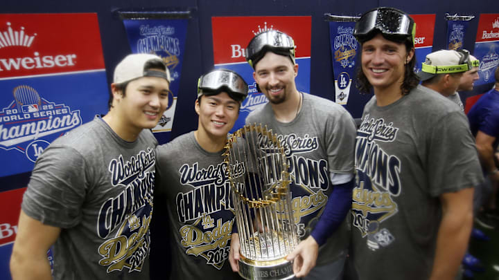 Oct 31, 2025; Toronto, Ontario, CAN; Los Angeles Dodgers two-way player Shohei Ohtani (17) and pitcher Yoshinobu Yamamoto (18) and pitcher Blake Snell (7) and pitcher Tyler Glasnow (31) celebrate with the Commissioner's Trophy in the clubhouse after defeating the Toronto Blue Jays in the 2025 MLB World Series at Rogers Centre. Mandatory Credit: John E. Sokolowski-Imagn Images