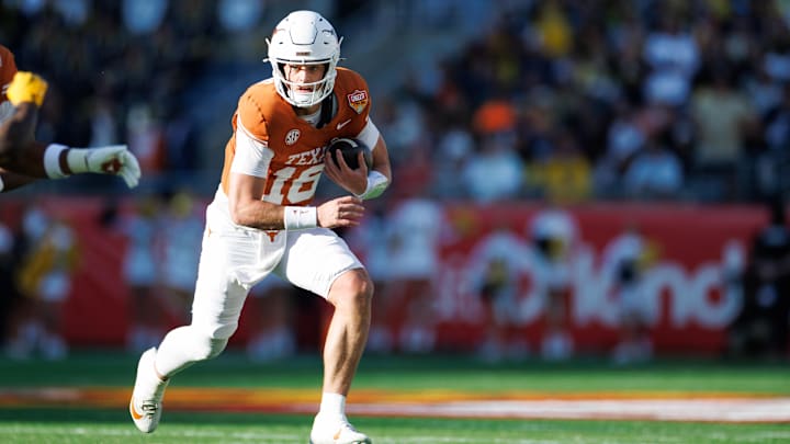 Dec 31, 2025; Orlando, FL, USA; Texas Longhorns quarterback Arch Manning (16) runs with the ball against the Michigan Wolverines during the first half.