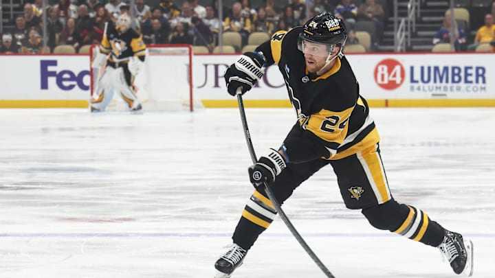 Mar 13, 2025; Pittsburgh, Pennsylvania, USA;  Pittsburgh Penguins defenseman Matt Grzelcyk (24) shoots the puck against the St. Louis Blues during the first period at PPG Paints Arena. Mandatory Credit: Charles LeClaire-Imagn Images