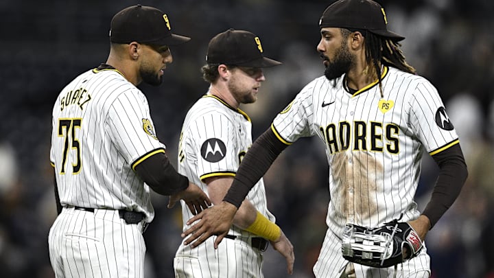 Apr 30, 2024; San Diego, California, USA; San Diego Padres right fielder Fernando Tatis Jr. (right) celebrates on the field with first baseman Jake Cronenworth (9) and relief pitcher Robert Suarez (75) after defeating the Cincinnati Reds at Petco Park. Mandatory Credit: Orlando Ramirez-Imagn Images