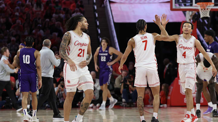 Feb 14, 2026; Houston, Texas, USA; Houston Cougars guard Kingston Flemings (4) celebrates guard Milos Uzan (7) three point basket against the Kansas State Wildcats in the first half at Fertitta Center. Mandatory Credit: Thomas Shea-Imagn Images