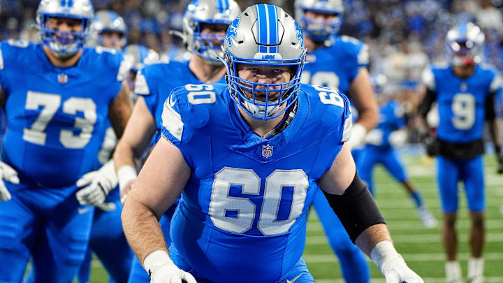 Detroit Lions guard Graham Glasgow (60) warms up before the NFC divisional round at Ford Field in Detroit on Saturday, Jan. 18, 2025.