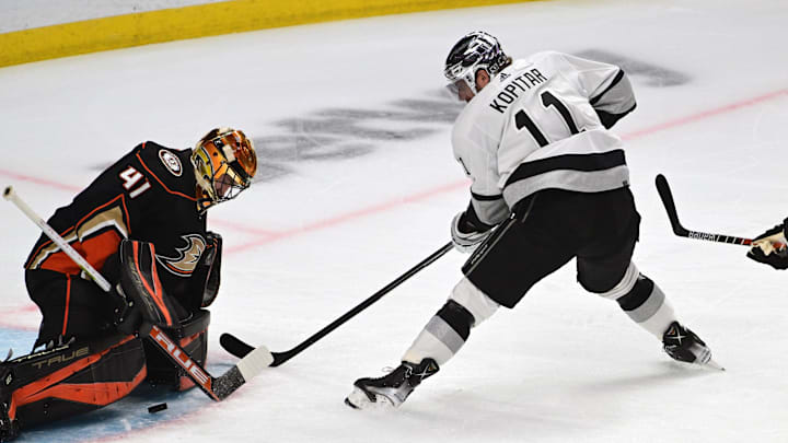 Apr 23, 2022; Los Angeles, California, USA; Los Angeles Kings center Anze Kopitar (11) controls the puck against Anaheim Ducks goaltender Anthony Stolarz (41) in the first period at Crypto.com Arena. Mandatory Credit: Richard Mackson-Imagn Images