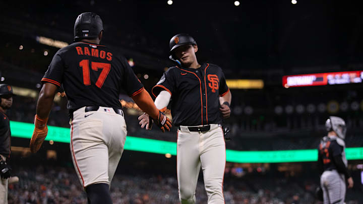 Mar 24, 2025; San Francisco, California, USA; San Francisco Giants center fielder Jung Hoo Lee (right) gets a congratulatory handshake from teammate Heliot Ramos.