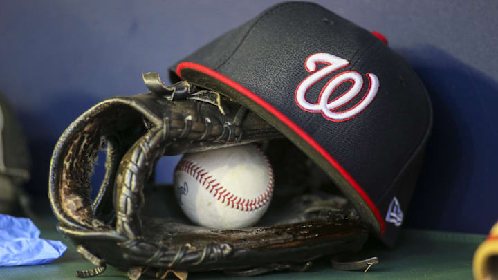 Dark blue Washington Nationals hat on top of a black mitt
