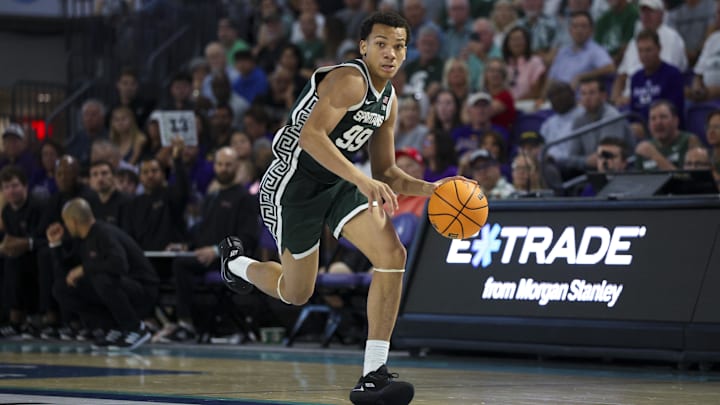 Nov 25, 2025; Fort Myers, Florida, USA; Michigan State Spartans guard Divine Ugochukwu (99) controls the ball against the East Carolina Pirates in the second half at Suncoast Credit Union Arena. Mandatory Credit: Nathan Ray Seebeck-Imagn Images