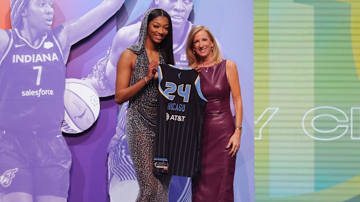 Angel Reese poses with WNBA commissioner Cathy Engelbert after she is selected by the Chicago Sky at the 2024 WNBA Draft.