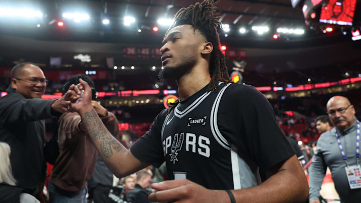 Apr 24, 2026; Portland, Oregon, USA; San Antonio Spurs guard Stephon Castle (5) high-fives fans after the Spurs defeated the Portland Trail Blazers in game three of the first round of the 2026 NBA Playoffs at Moda Center. Mandatory Credit: Jaime Valdez-Imagn Images