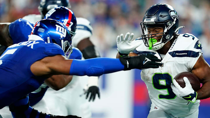 Seattle Seahawks running back Kenneth Walker III (9) rushes with pressure from New York Giants linebacker Kayvon Thibodeaux (5) in the first half at MetLife Stadium on Monday, Oct. 2, 2023, in East Rutherford.