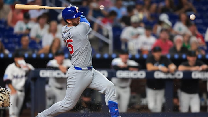 May 20, 2025; Miami, Florida, USA; Chicago Cubs catcher Carson Kelly (15) hits a single against the Miami Marlins during the sixth inning at loanDepot Park. May 20, 2025; Miami, Florida, USA; Chicago Cubs catcher Carson Kelly (15) hits a single against the Miami Marlins during the sixth inning at loanDepot Park.