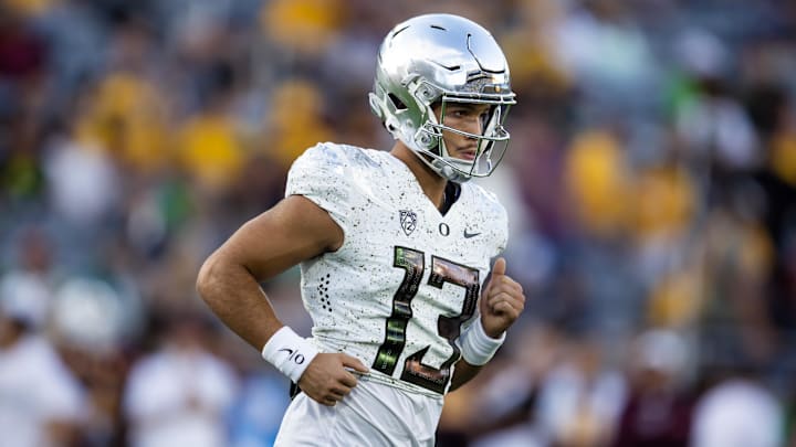Nov 18, 2023; Tempe, Arizona, USA; Oregon Ducks quarterback Ty Thompson (13) against the Arizona State Sun Devils at Mountain America Stadium. Mandatory Credit: Mark J. Rebilas-USA TODAY Sports