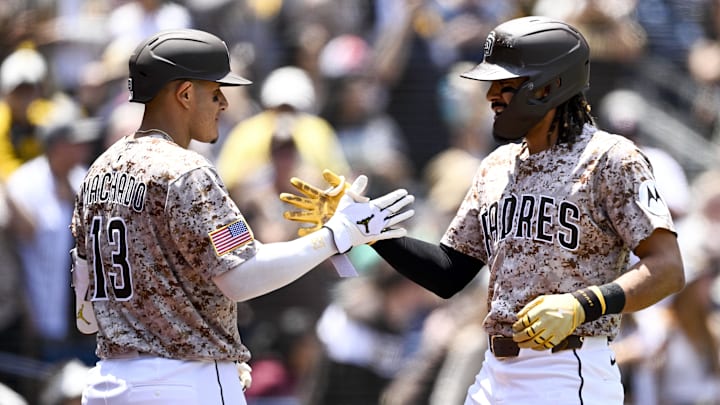 May 18, 2025; San Diego, California, USA; San Diego Padres right fielder Fernando Tatis Jr. (23) is congratulated by Manny Machado (13) after hitting a solo home run during the first inning against the Seattle Mariners at Petco Park. Mandatory Credit: Denis Poroy-Imagn Images