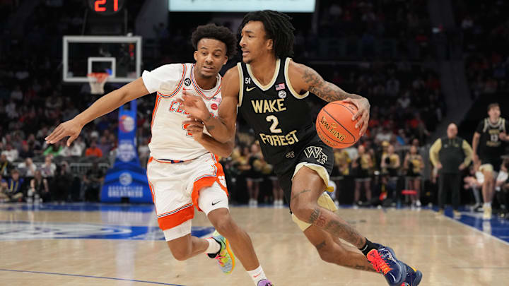 Mar 11, 2026; Charlotte, NC, USA; Wake Forest Demon Deacons forward Juke Harris (2) with the ball as Clemson Tigers guard Efrem Johnson (4) defends in the first half at Spectrum Center. Mandatory Credit: Bob Donnan-Imagn Images