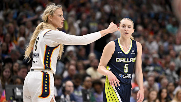 Aug 1, 2025; Dallas, Texas, USA;  Indiana Fever guard Sophie Cunningham (8) reacts to a foul call against Dallas Wings guard Paige Bueckers (5) during the first half at the American Airlines Center. Mandatory Credit: Jerome Miron-Imagn Images