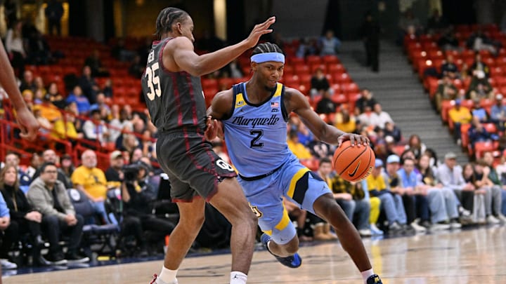 Nov 28, 2025; Chicago, Illinois, USA; Marquette Golden Eagles guard Chase Ross (2) drives against Oklahoma Sooners forward Derrion Reid (35) during the second half at Credit Union 1 Arena.