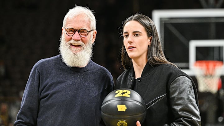 Feb 2, 2025; Iowa City, Iowa, USA; Former Iowa Hawkeyes player Caitlin Clark and comedian David Letterman react after the game at Carver-Hawkeye Arena against the USC Trojans. The Hawkeyes retired the jersey of Clark after the game. Mandatory Credit: Jeffrey Becker-Imagn Images Feb 2, 2025; Iowa City, Iowa, USA; Former Iowa Hawkeyes player Caitlin Clark and comedian David Letterman react after the game at Carver-Hawkeye Arena against the USC Trojans. The Hawkeyes retired the jersey of Clark after the game. Mandatory Credit: Jeffrey Becker-Imagn Images