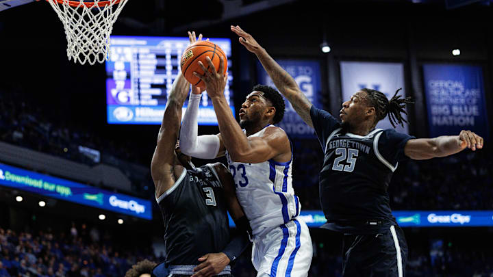 Oct 30, 2025; Lexington, KY, USA; Kentucky Wildcats forward Mouhamed Dioubate (23) goes to the basket against Georgetown Hoyas center Vincent Iwuchukwu (3) and guard Jeremiah Williams (25) during the second half at Rupp Arena at Central Bank Center. Mandatory Credit: Jordan Prather-Imagn Images Oct 30, 2025; Lexington, KY, USA; Kentucky Wildcats forward Mouhamed Dioubate (23) goes to the basket against Georgetown Hoyas center Vincent Iwuchukwu (3) and guard Jeremiah Williams (25) during the second half at Rupp Arena at Central Bank Center. Mandatory Credit: Jordan Prather-Imagn Images