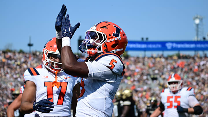 Oct 4, 2025; West Lafayette, Indiana, USA; Illinois Fighting Illini running back Ca'Lil Valentine (5) celebrates a touchdown during the second quarter against the Purdue Boilermakers at Ross-Ade Stadium. Mandatory Credit: Marc Lebryk-Imagn Images