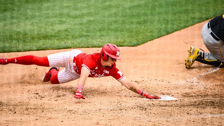 Drew Grego slides home to score a run on a sac fly versus Iowa. Drew Grego slides home to score a run on a sac fly versus Iowa.