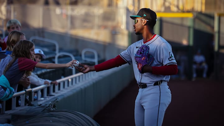 Arizona Diamondbacks third base prospect LuJames Groover signs a ball for a young fan in the Arizona Fall League
