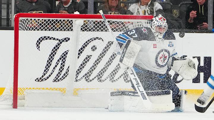 Apr 13, 2026; Las Vegas, Nevada, USA; Winnipeg Jets goaltender Connor Hellebuyck (37) makes a save against the Vegas Golden Knights during the first period at T-Mobile Arena. Mandatory Credit: Stephen R. Sylvanie-Imagn Images