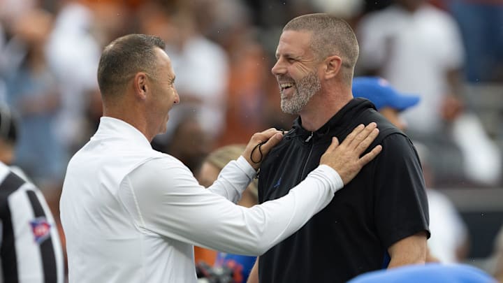 Texas head coach Steve Sarkisian, left, and Florida head coach Billy Napier meet mid field before an NCAA football game in Gainesville, FL on Saturday, October 4, 2025. [Alan Youngblood/Gainesville Sun]