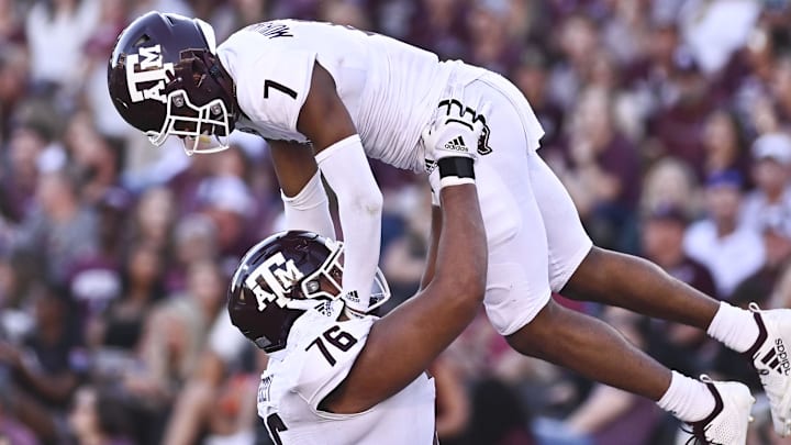 Oct 1, 2022; Starkville, Mississippi, USA; Texas A&M Aggies wide receiver Moose Muhammad III (7) reacts with offensive lineman Reuben Fatheree II (76) after a touchdown against the Mississippi State Bulldogs during the third quarter at Davis Wade Stadium at Scott Field. Mandatory Credit: Matt Bush-Imagn Images