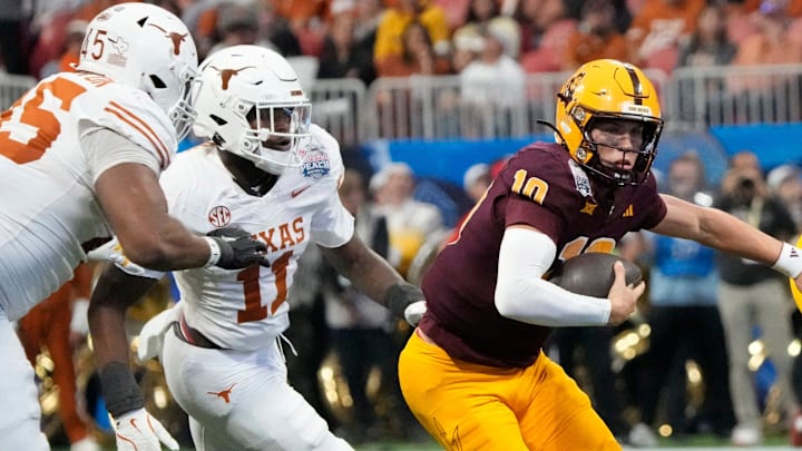 Arizona State quarterback Sam Leavitt (10) scrambles away from Texas linebacker Colin Simmons (11) during the second quarter of the Chick-fil-A Peach Bowl in Atlanta on Wednesday, Jan. 1, 2025. Arizona State quarterback Sam Leavitt (10) scrambles away from Texas linebacker Colin Simmons (11) during the second quarter of the Chick-fil-A Peach Bowl in Atlanta on Wednesday, Jan. 1, 2025.