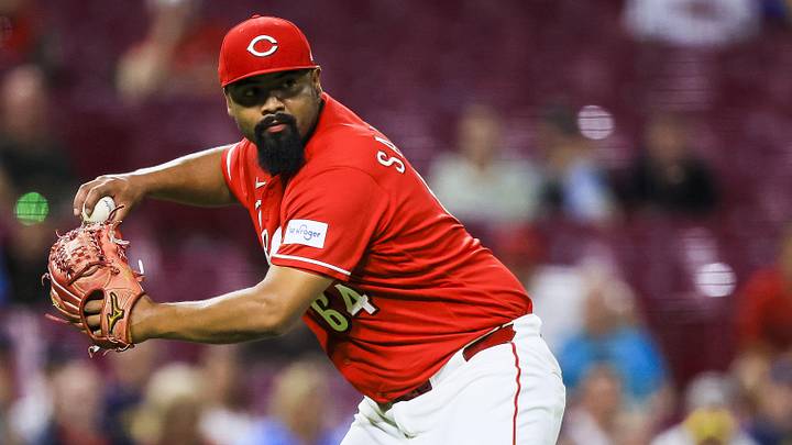Jun 22, 2026; Cincinnati, Ohio, USA; Cincinnati Reds relief pitcher Tony Santillan (64) throws to first to get Milwaukee Brewers outfielder Sal Frelick (not pictured) out in the tenth inning at Great American Ball Park. Mandatory Credit: Katie Stratman-Imagn Images
