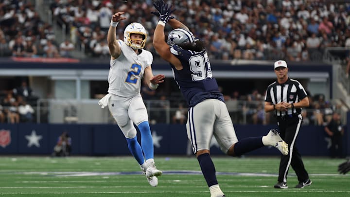 Aug 24, 2024; Arlington, Texas, USA; Los Angeles Chargers quarterback Easton Stick (2) throws a pass against Dallas Cowboys defensive lineman Viliami Fehoko (93) in the second quarter at AT&T Stadium. Mandatory Credit: Tim Heitman-USA TODAY Sports