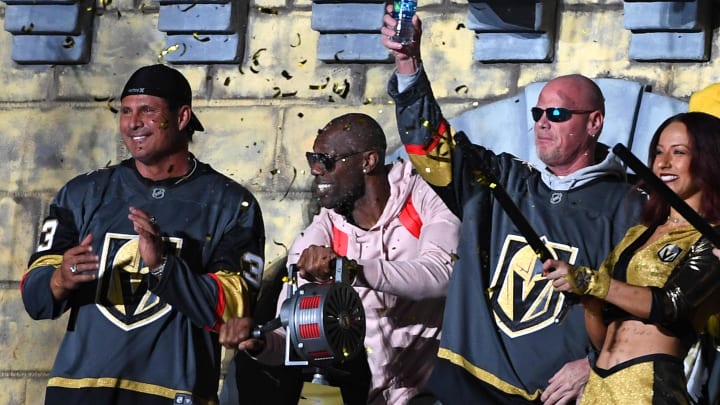 Feb 11, 2018; Las Vegas, NV, USA; Former professional athletes Terrell Owens (center) cranks a siren